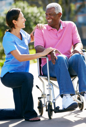 caregiver laughing together with the elder man